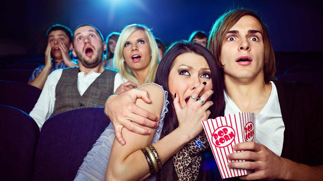 A group fo movie watchers in awe of the fascinating movie Aliens.