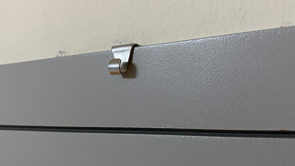 A picture hanger clip is included. It need not be placed in the center of the Hornady Security SnapSafe In-Wall Safe frame.