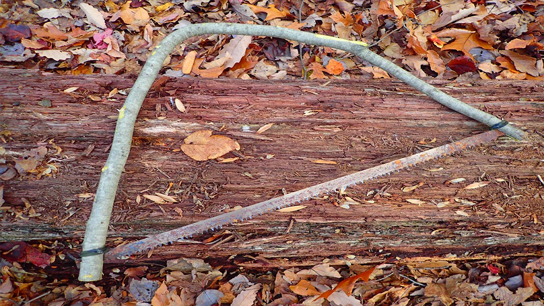 The author made a quick field-expedient bow saw when he found his 24-inch bucksaw frame broken in his semi-permanent camp.