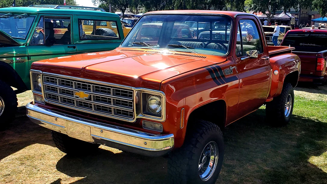 A retromod Stepside Chevy 4x4 at a classic truck show.