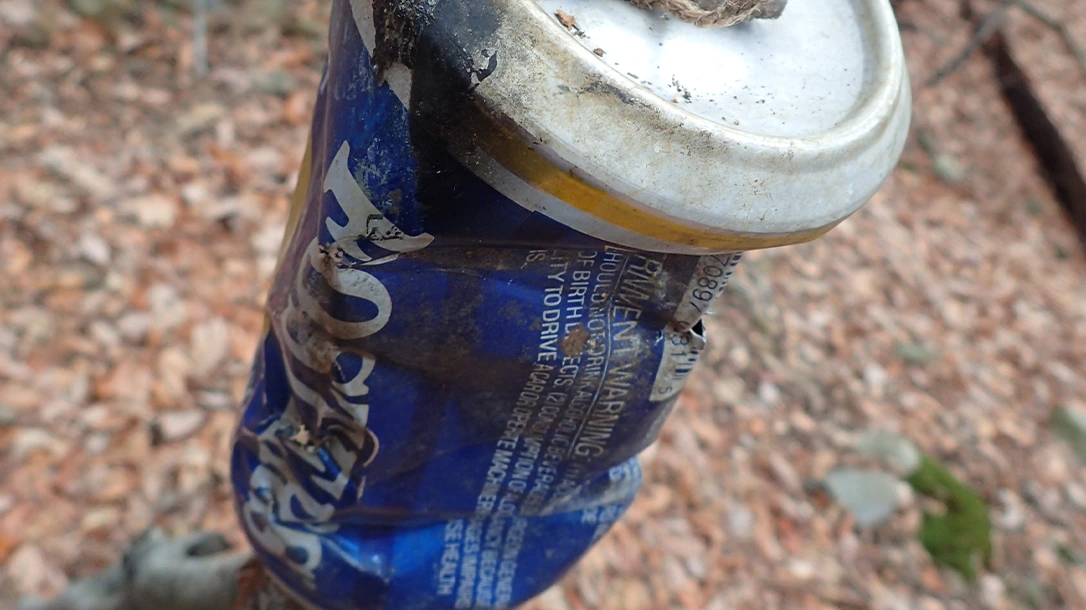 The top has a hole for a cord that connects to another stick to suspend the pot or kettle. A water bottle can also be used as a tripod stand holder.