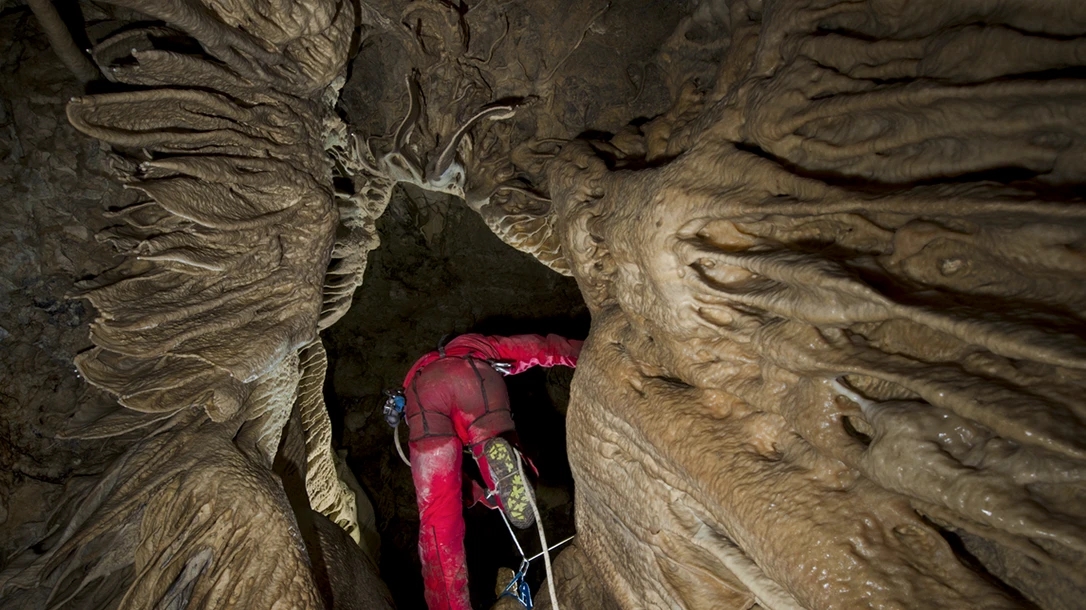 Cave explorers often work in darkly lit and uncomfortable, compact locations.
