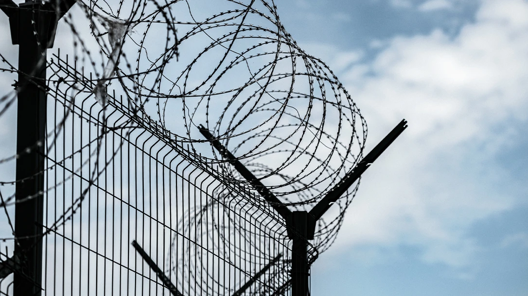 Prison barb wire fence to keep the criminals in.