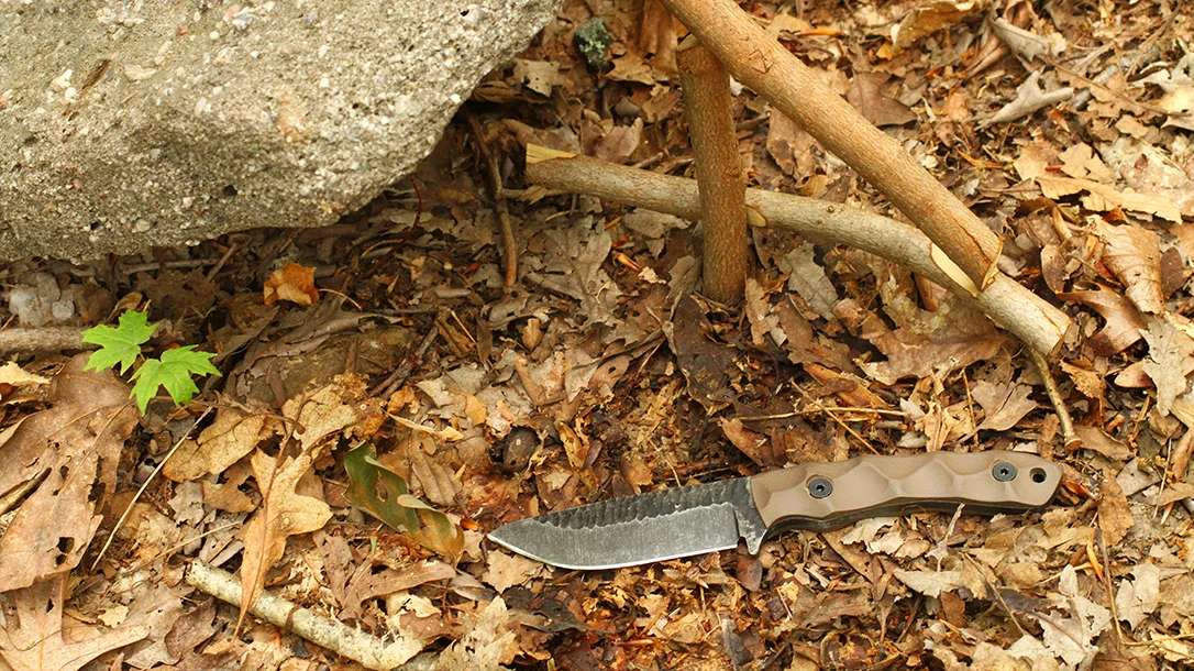 The author split larger pieces of maple and oak with a baton and the Mountain Predator Bowie for their woodpile.