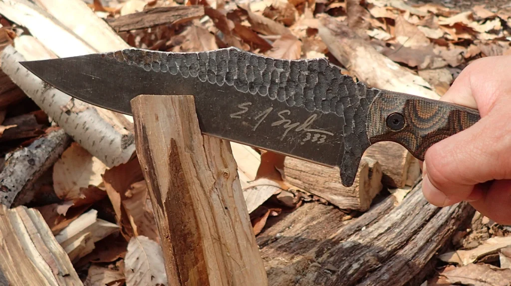 The Mountain Predator Bowie splitting small hardwood rounds for a woods cookout.