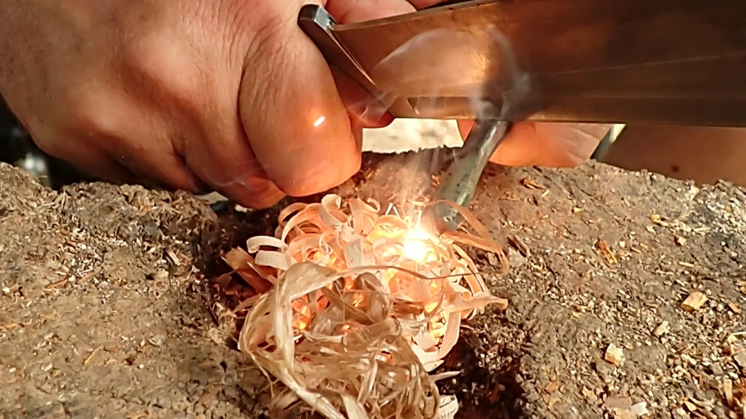 The thumb-on-thumb or thumb-assisted method involves holding a knife against the Ferro rod and using the friction of both thumbs to scrape sparks on the tinder.
