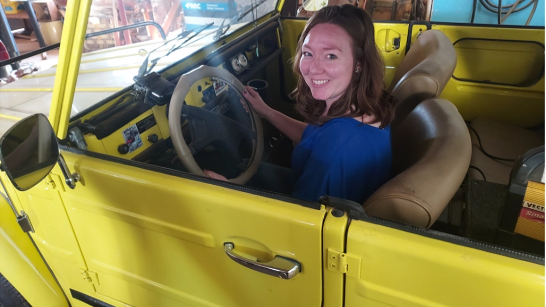 The Author sits in a restored volkswagon thing.