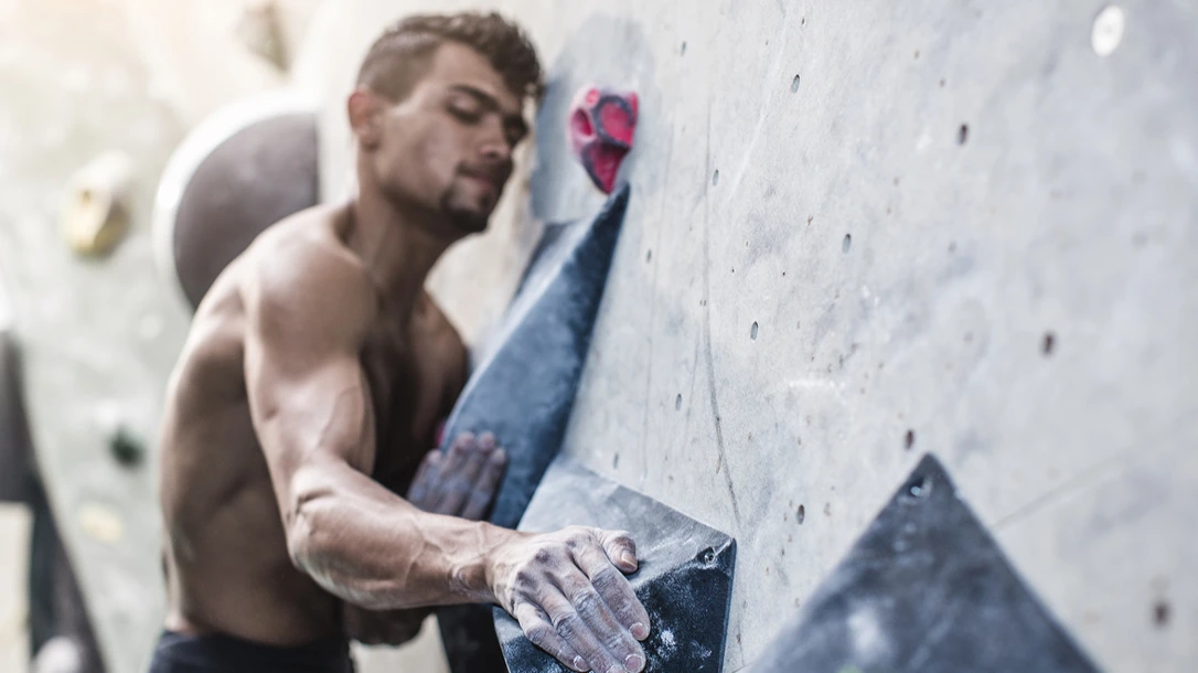 A free climbers only gear is a pair of climbing shoes and a chalk bag tied around their waist.