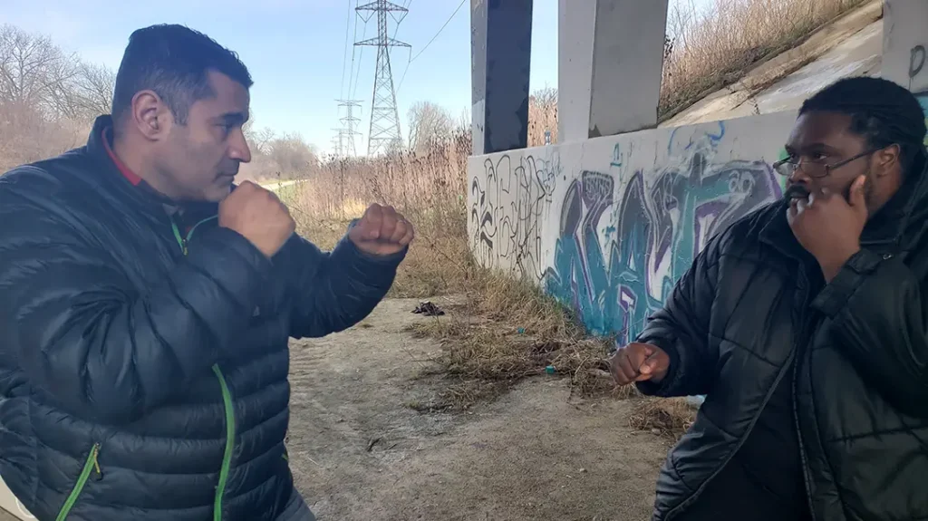 How to Throw a Punch: Thomas and Kysean square off. Both Thomas and Kysean have their hands up, ready to fight.