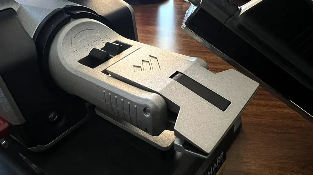 On the front of the frame is the metal V-Block Clamp, which is designed to secure your knife in place.
