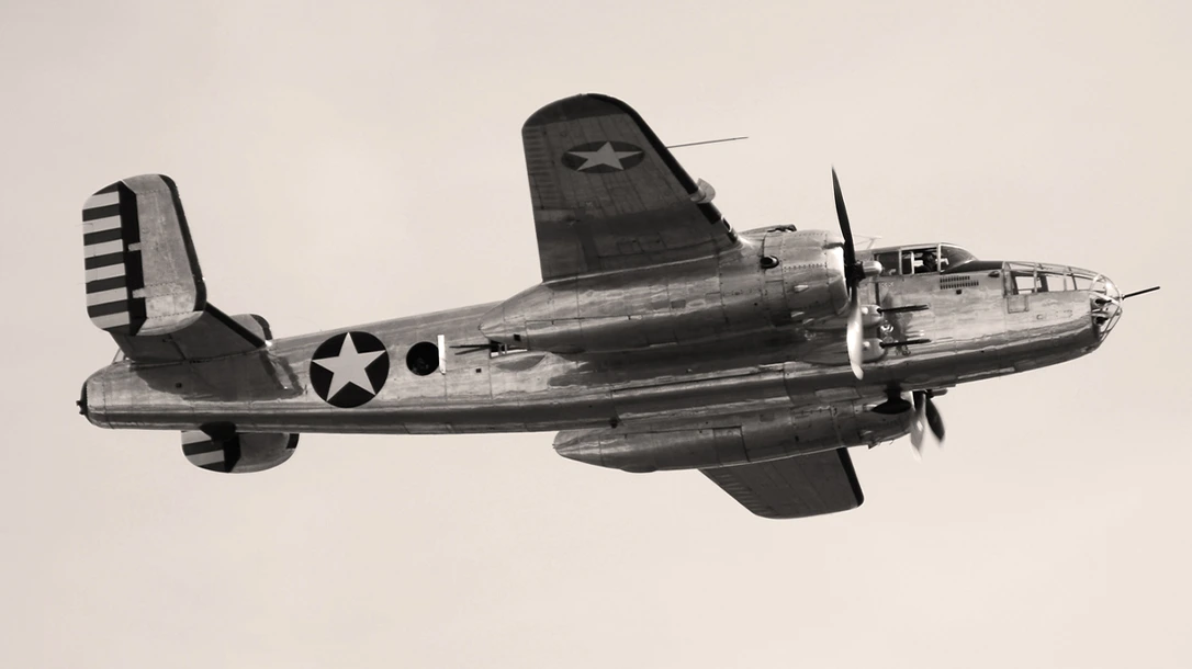 A WW2 bomber plane flies overhead on a dangerous mission.