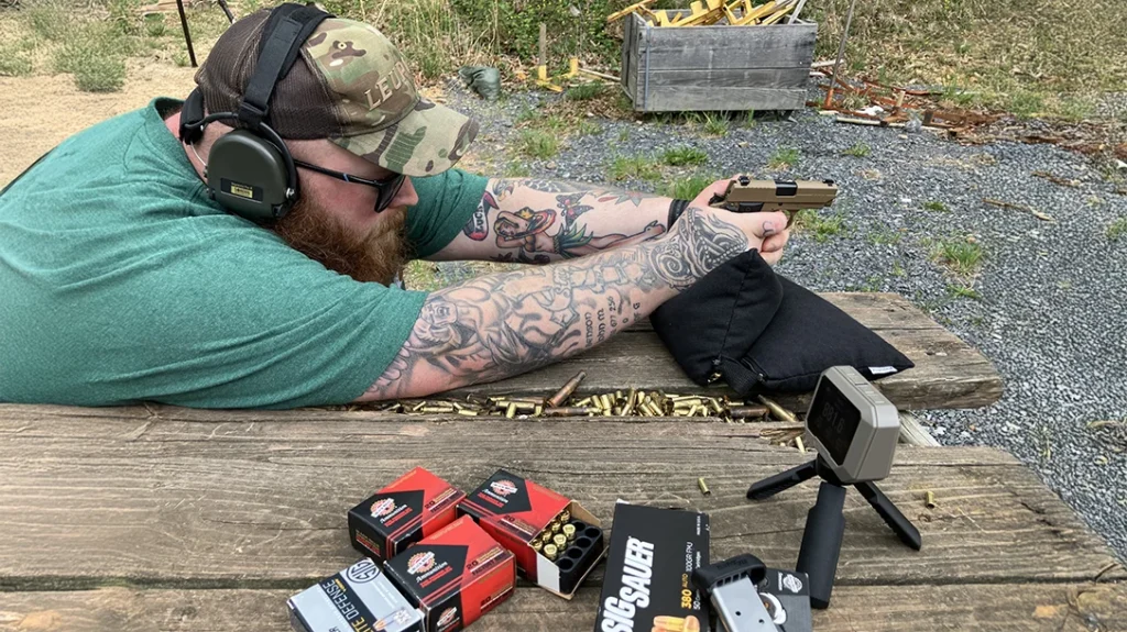 Firing the SIG Sauer P238 Emperor Scorpion from the bench with bag support verifying accuracy and chronographing loads.