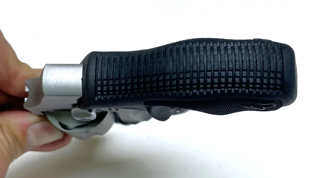 The grip is ambidextrous, and neither protruding thumb-rests nor the checking on the sides and backstrap abrade the palm in recoil.